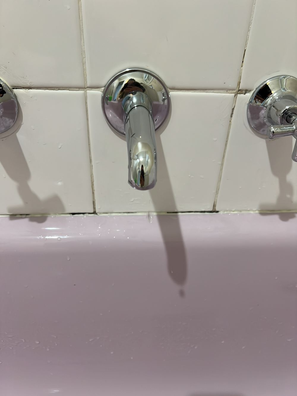 Old bath sealant blackened with mould and due for replacement, found during a pre-purchase inspection in Dandenong North